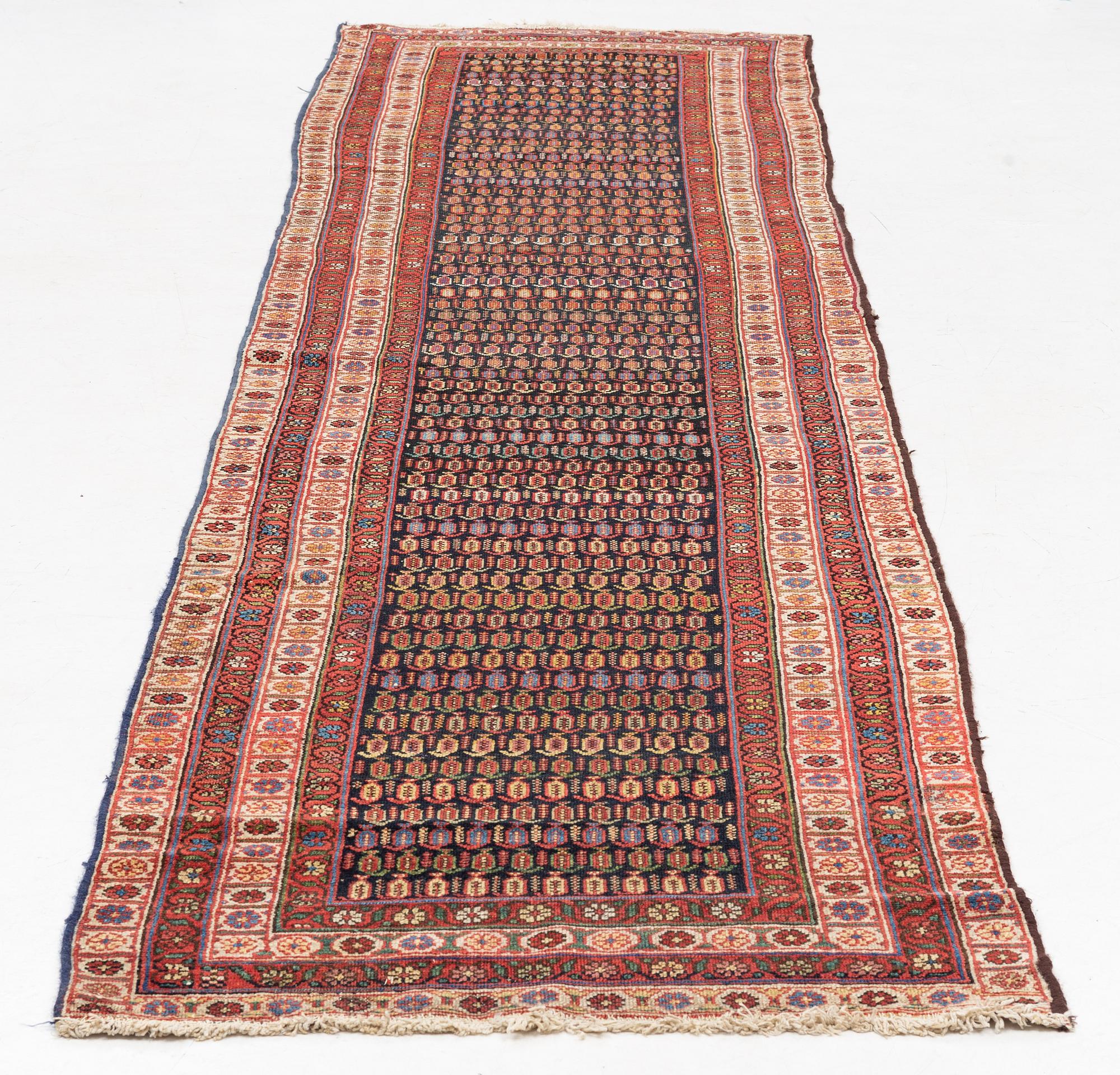 An antique runner carpet, approx. 400 x 93 cm.