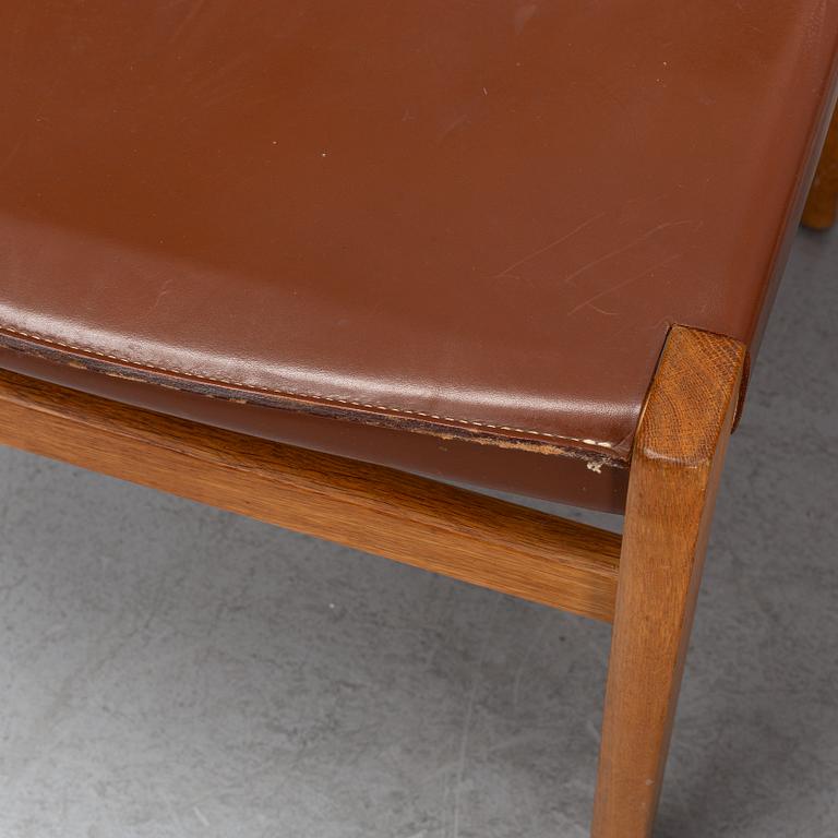 Four oak chairs with leather seat by John Vedel Rieper, Denmark, 1962.