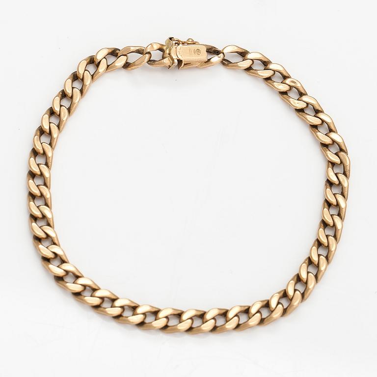 A 14K gold bracelet.