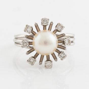 An 18K gold ring set with a cultured pearl and round brilliant-cut diamonds.