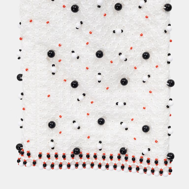 Chanel, a pair of broderie anglais trousers with pearls, size 34.