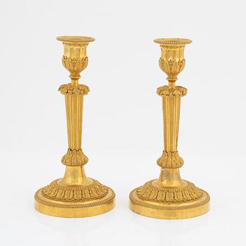 A pair of gilded bronze candelsticks, 19th Century.