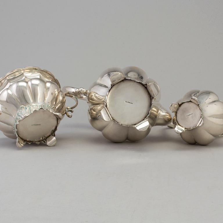 A three piece silver coffee set dated 1916-17.