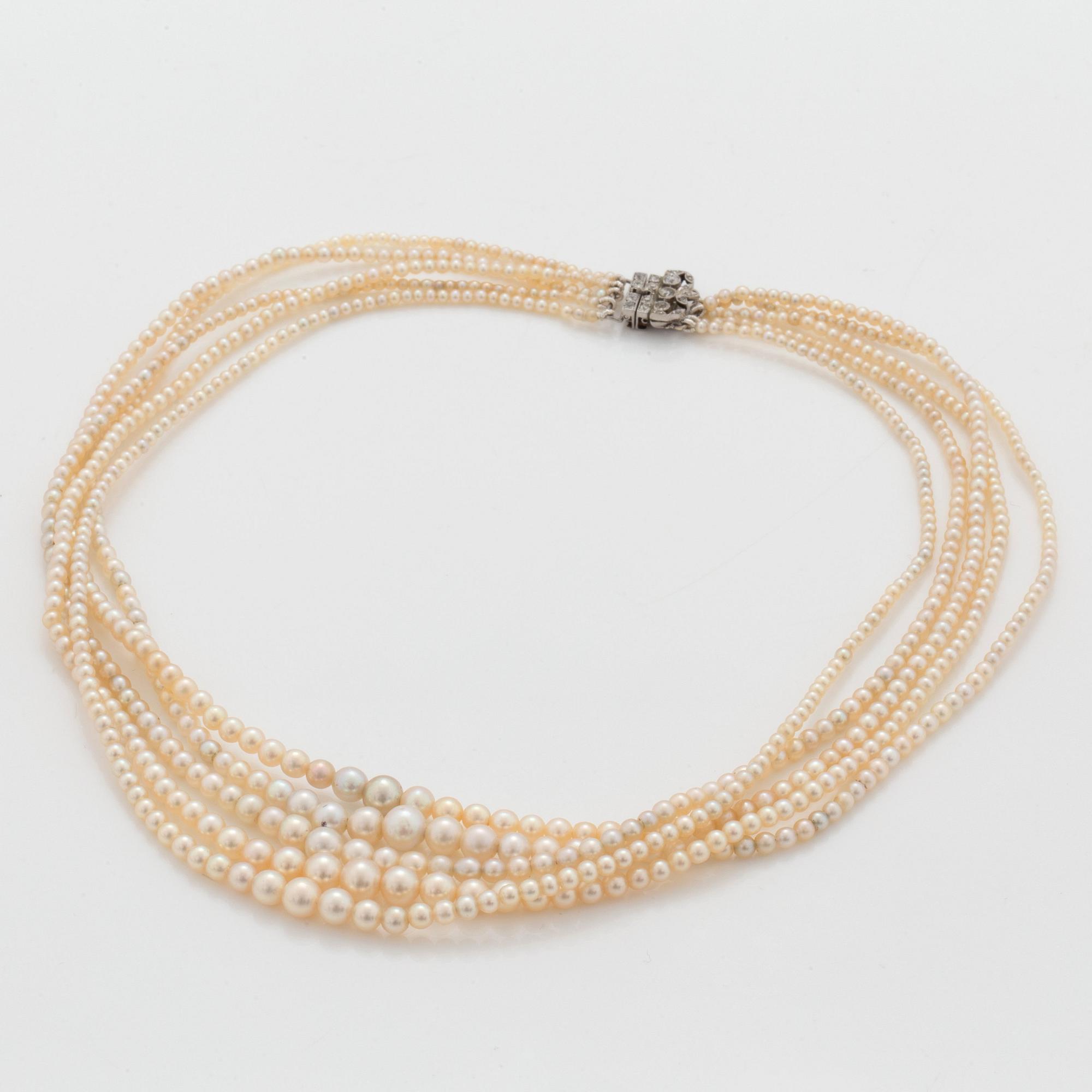 A 5-strand natural saltwater pearl necklace (one pearl cultured) Clasp with diamonds. Certificate from GCS.