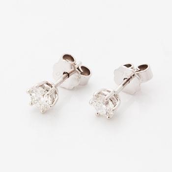 Brilliant-cut diamond stud earrings.