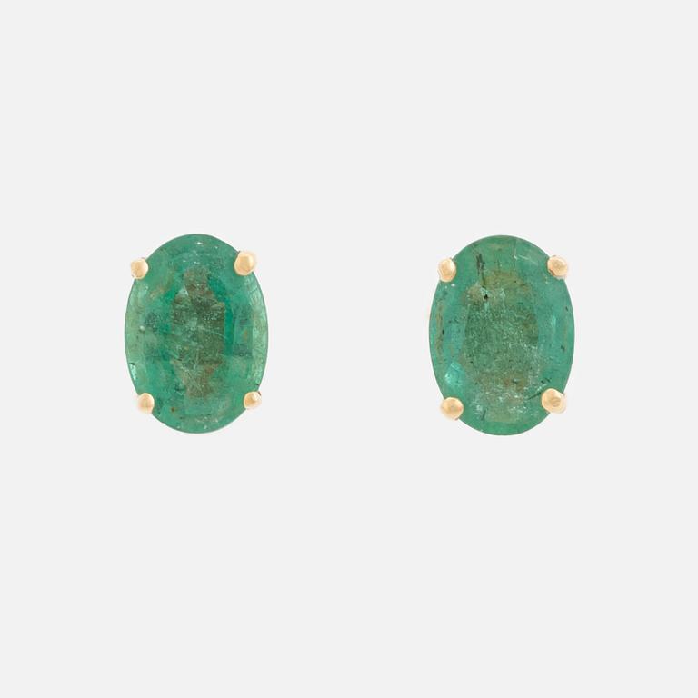 Gold and oval emerald earrings.