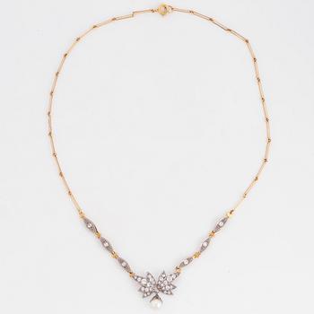 18K gold necklace with white stones and pearl.