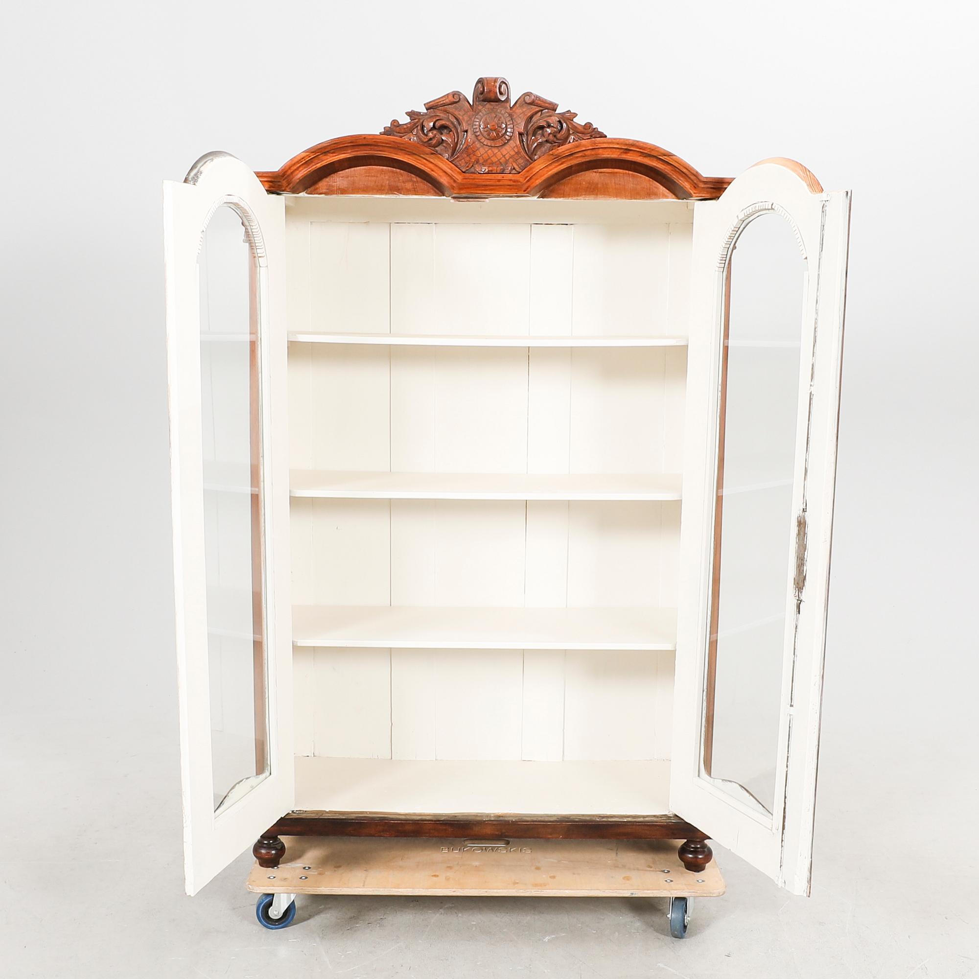 A walnut display cabinet around 1900.