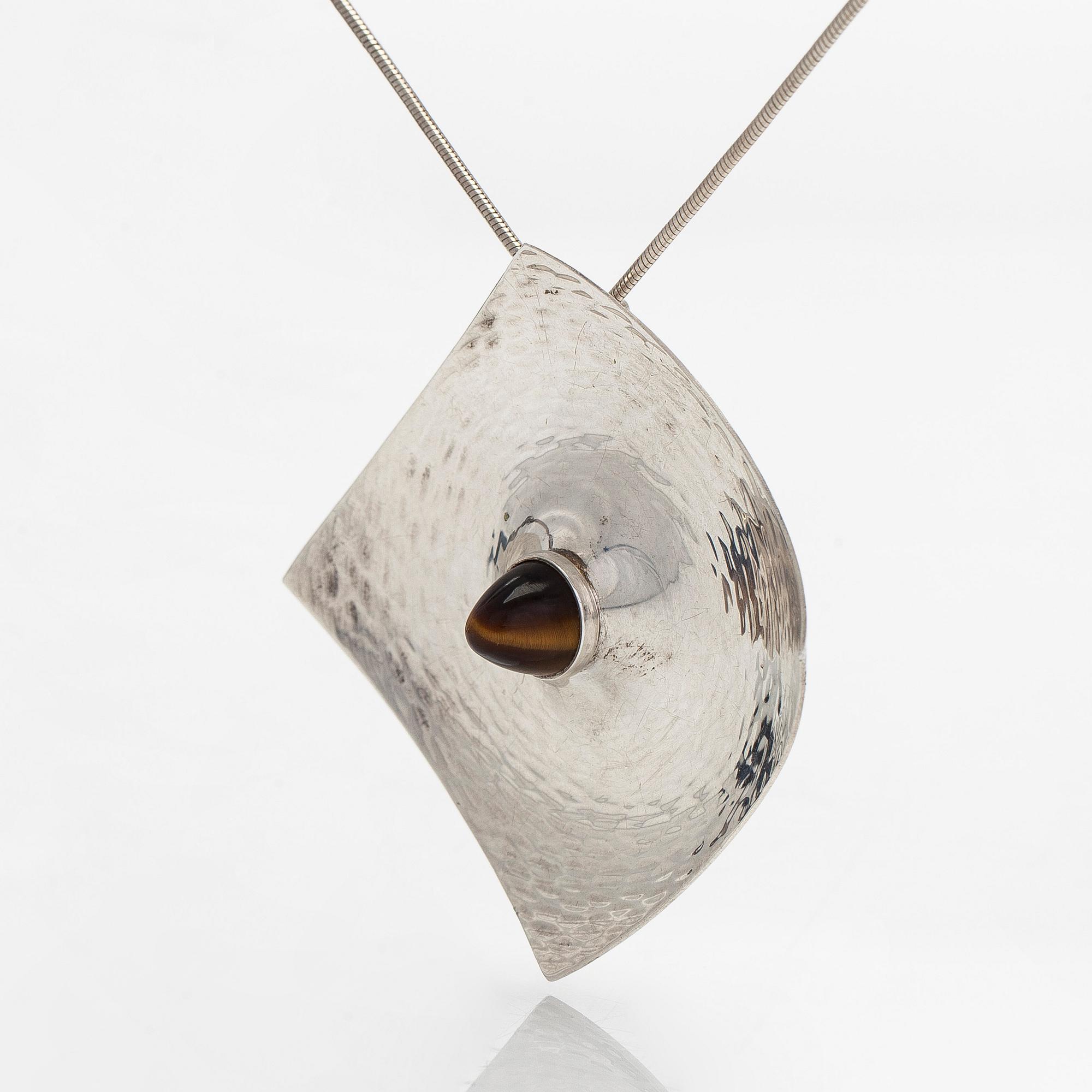Elis Kauppi, a silver brooch/pendant, and tiger's eye. Kupittaan Kulta, Turku 1962.