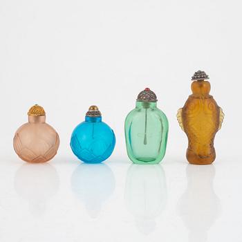 A group of four glass snuff bottles with stoppers, China, 20th century.