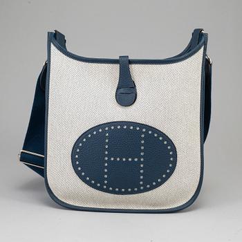 HERMÈS, a canvas and blue leather crossbody bag, "Evelyn".