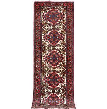 An oriental runner carpet, c. 295 x 95 cm.