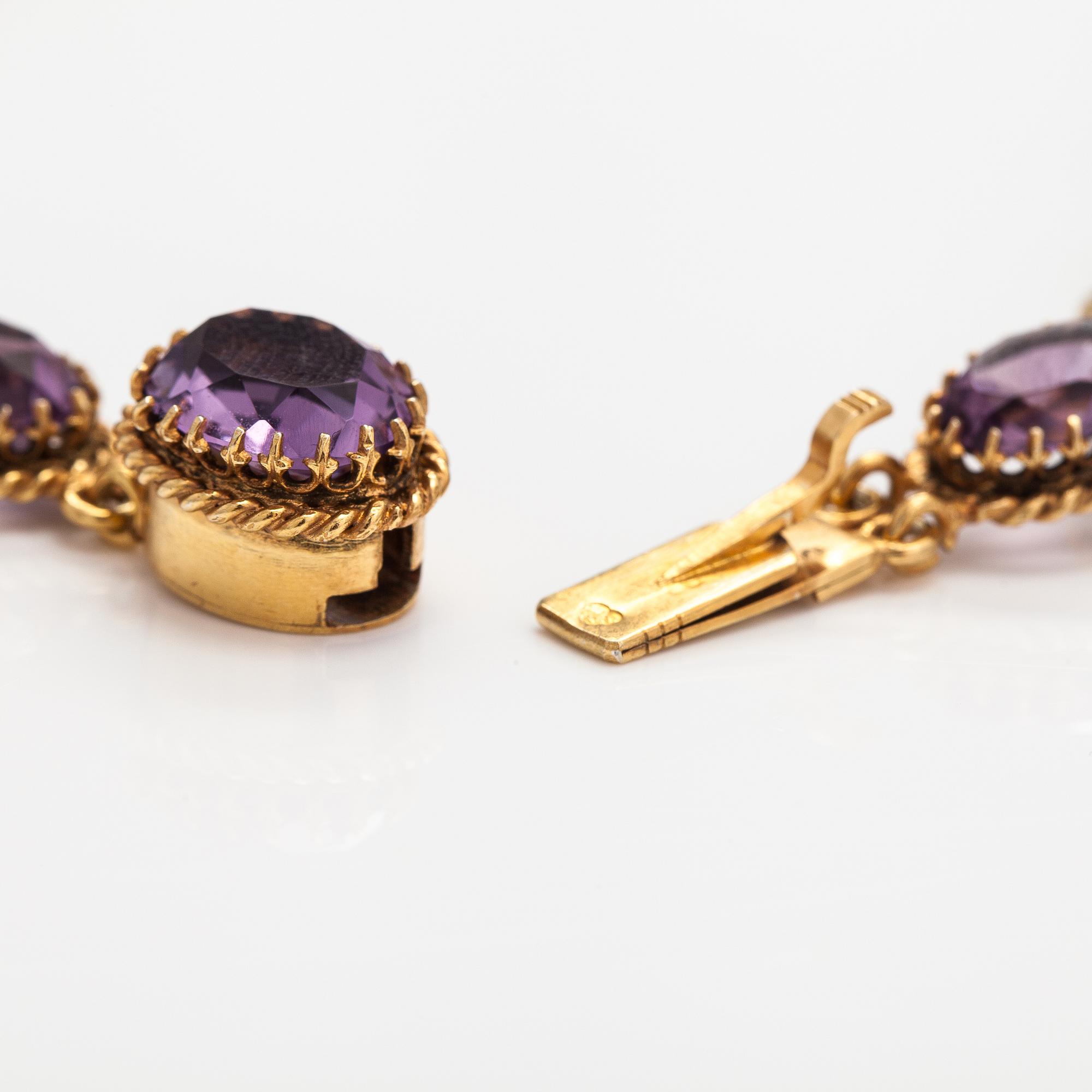 A necklace, bracelet and two brooches in gilded silver and with amethysts and pearls.