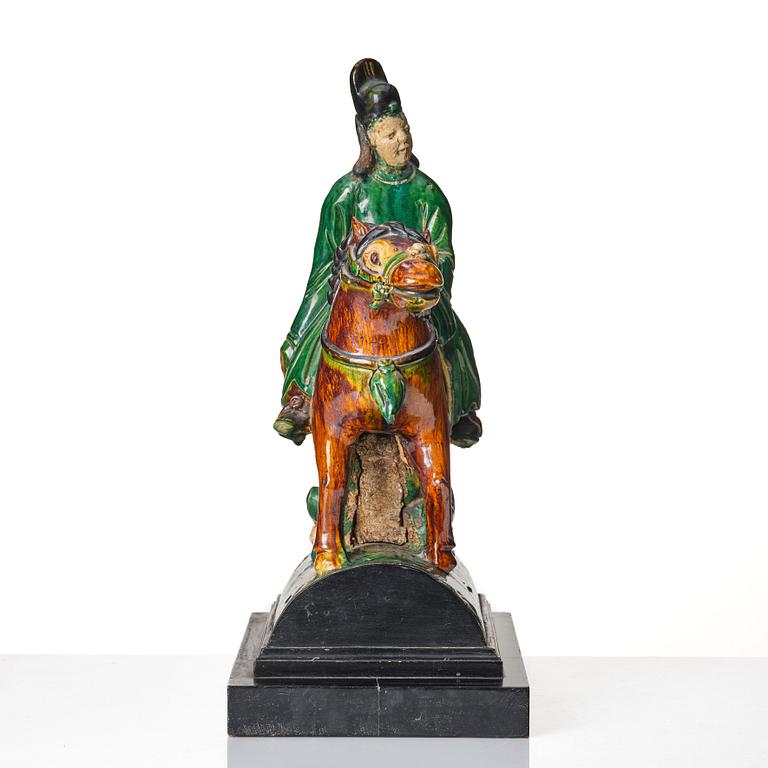 A Chinese glazed stoneware ridge tile figure of a mandarin official on a horse, Ming dynasty (1368-1644).