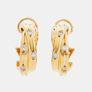 A pair of Cartier "Trinity" earrings in 18K gold set with round brilliant-cut diamonds.