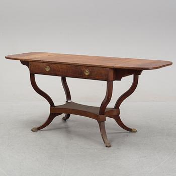 An Empire style mahogany  center table from around the year 1900.