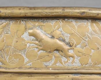 A Baroque brass wine cooler.