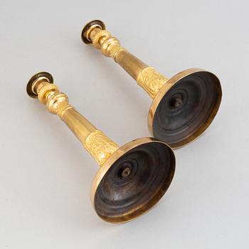 A pair of french gilt bronze candle holders, around 1820.