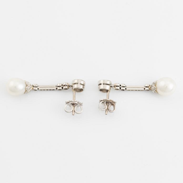 A pair of platinum pearl earings.