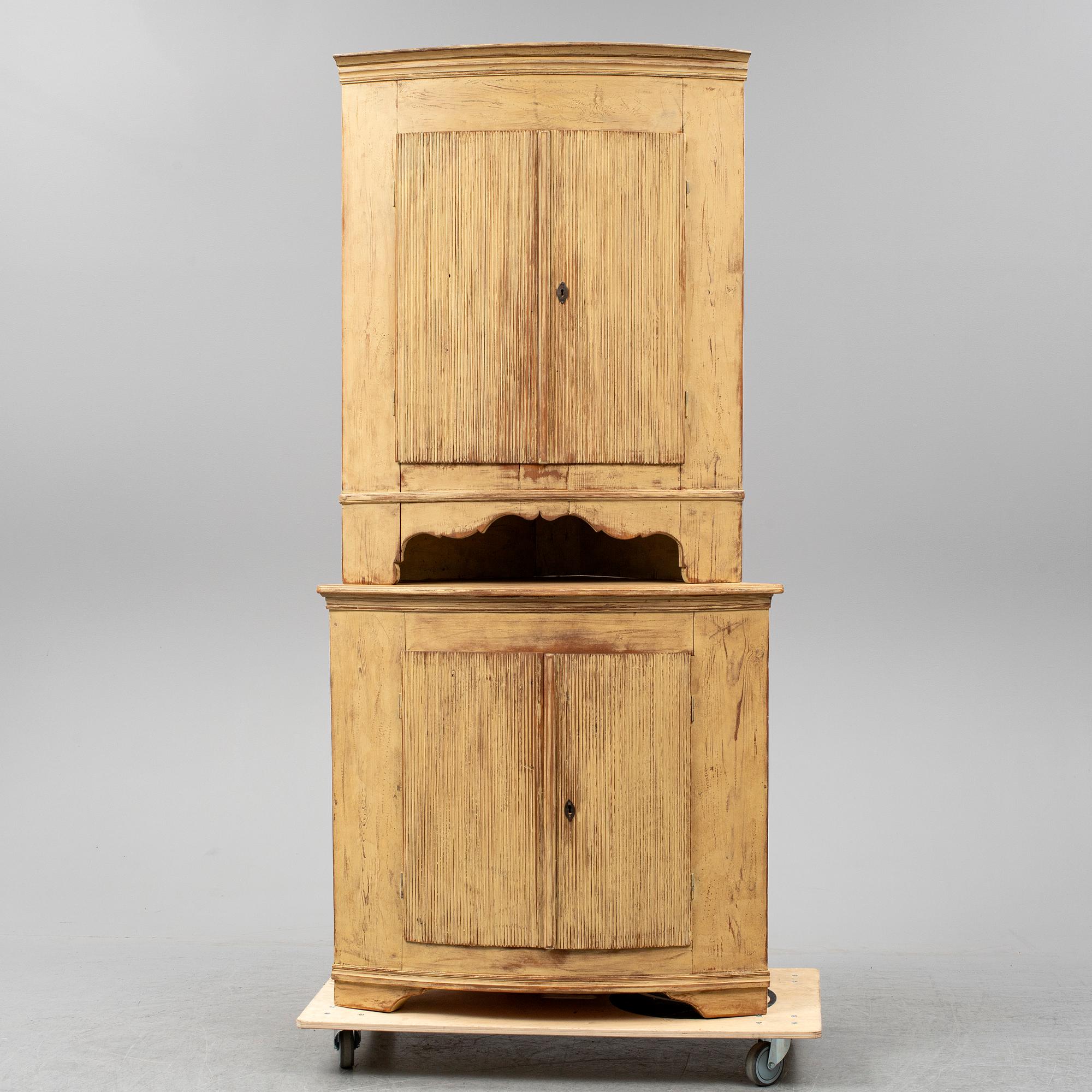 A Swedish late Gustavian corner cabinet in two parts.