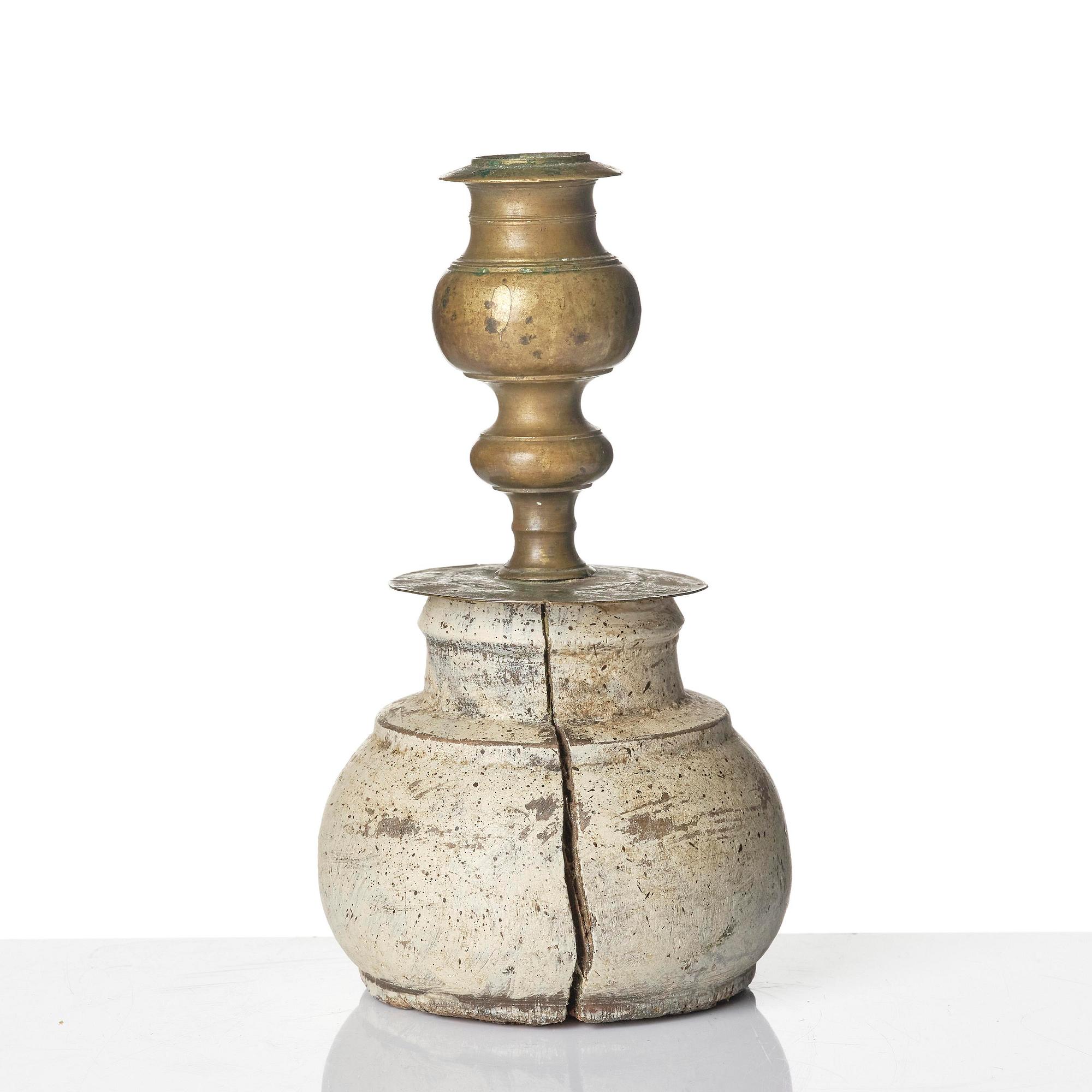 A Northern European baroque candlesticks, late 17th century, with a repaired wooden base.