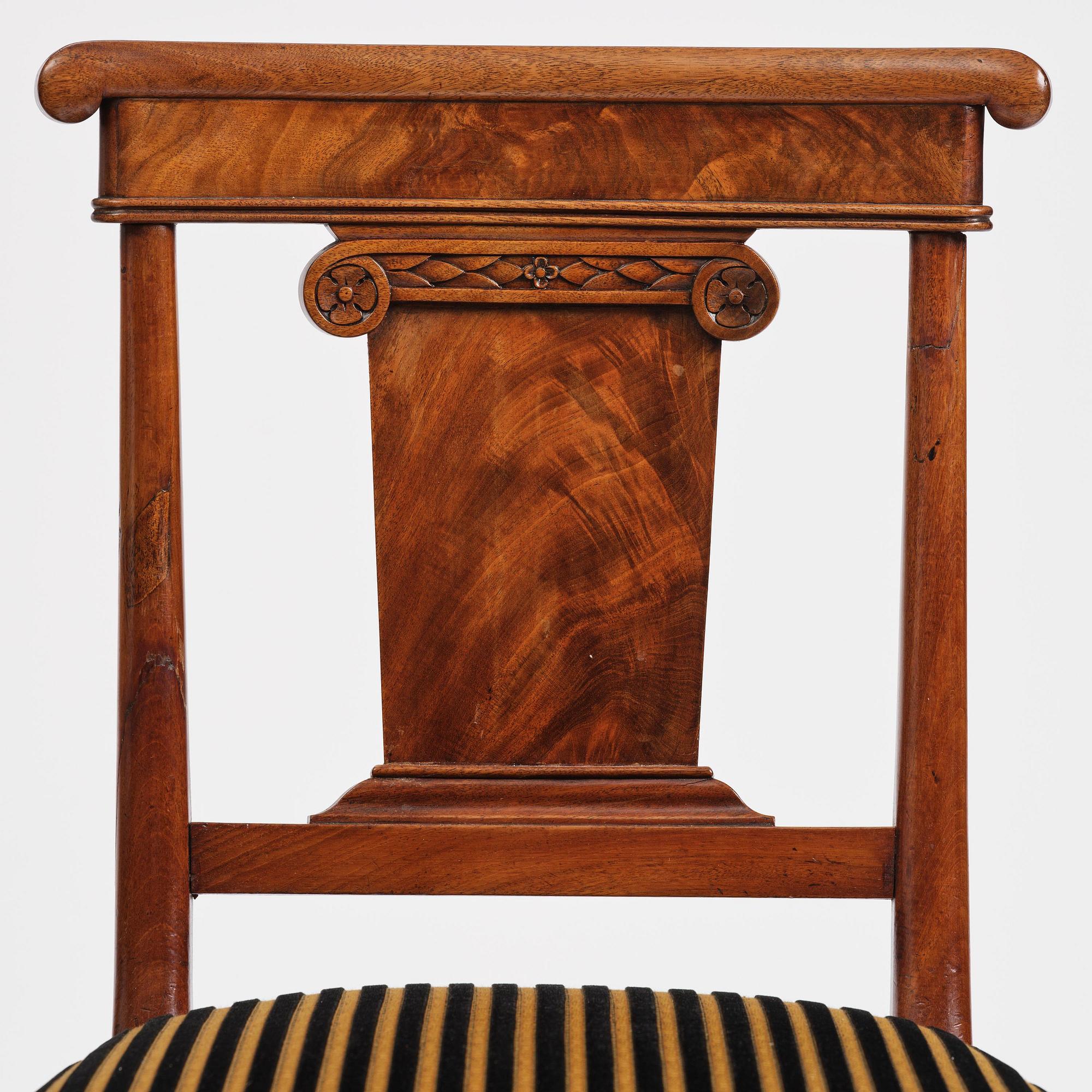 A set of nine Charles X mahogny dining chairs.
