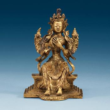 1383. A Sino-Tibetan gilt bronze figure of Maitreya.