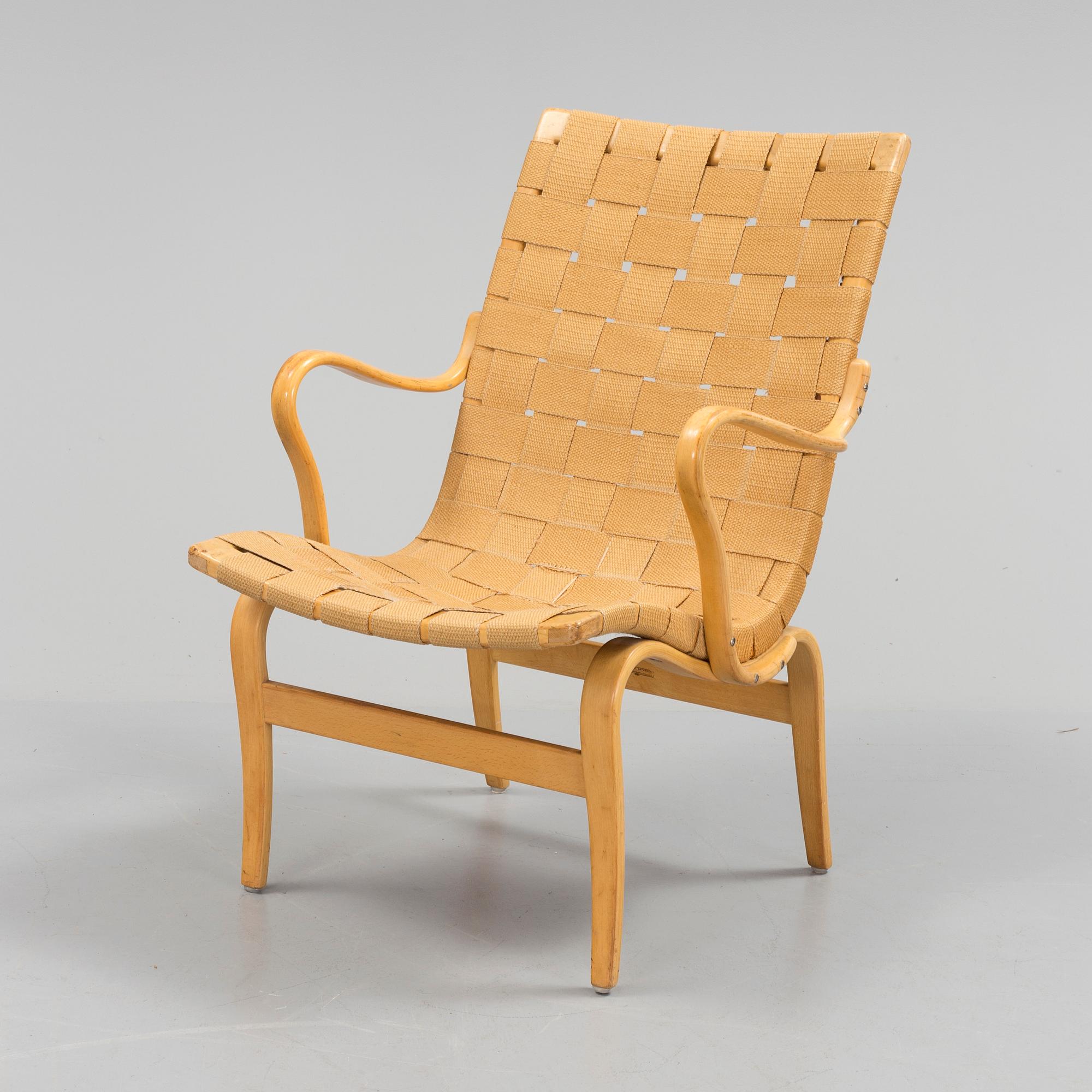 an "Eva" armchair by BRUNO MATHSSON 1963.
