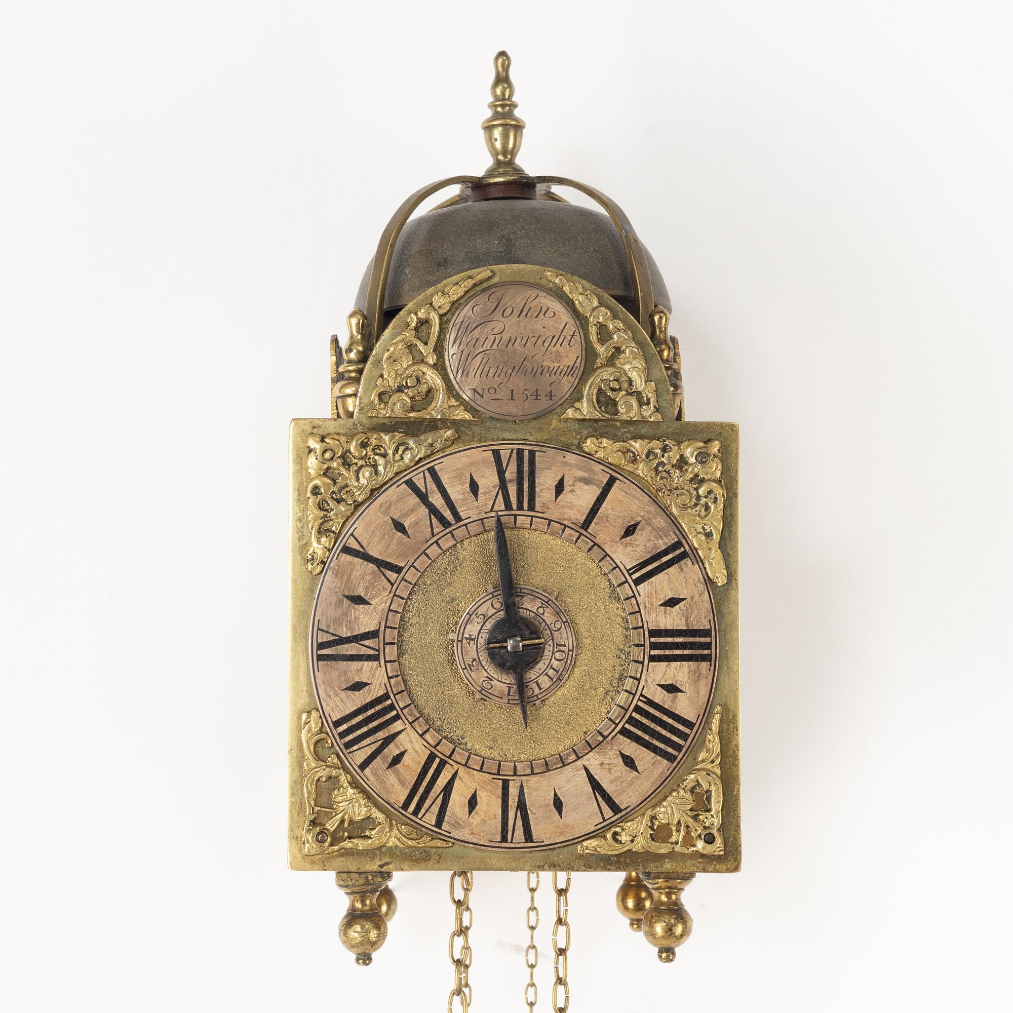 A George II brass lantern clock by John Wainwright (watchmaker in Wellingborough 1738-51).