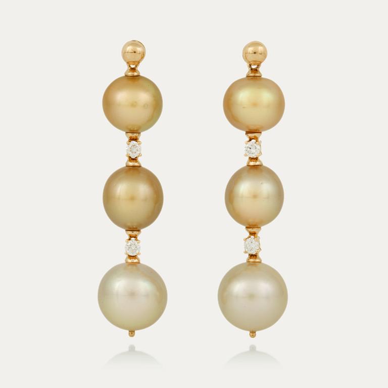 A pair of yellow toned cultured South Sea pearl and brilliant-cut diamond earrings.