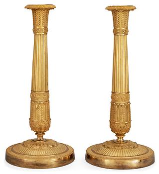 617. A pair of French Empire early 19th century candlesticks.