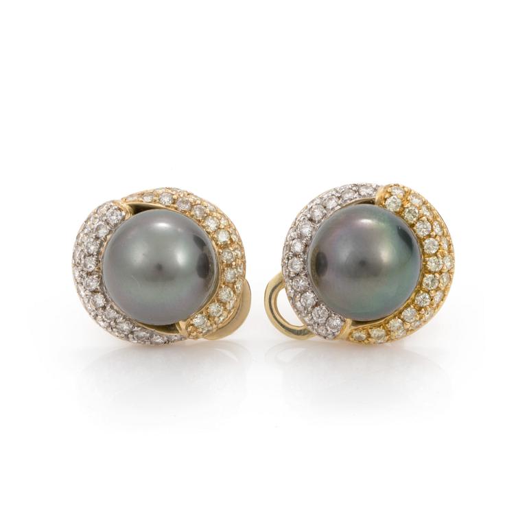 A pair of cultured tahiti pearl earrings with brilliant cut diamond jackets.