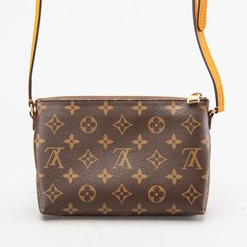 A Louis Vuitton Pallas clutch.