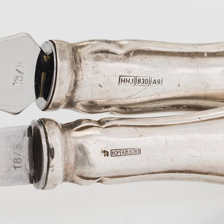 A 47-piece set of 'Chippendale' silver cutlery and a pair of silver candlesticks, Finnish marks 1983-2003 and 1976.