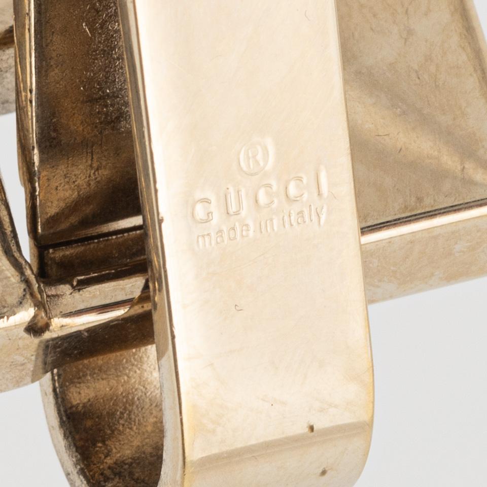Gucci, a red leather handbag.