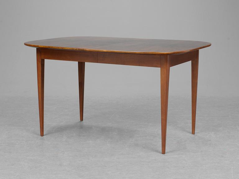 A Josef Frank walnut and mahogany dinner table, Firma Svenskt Tenn.