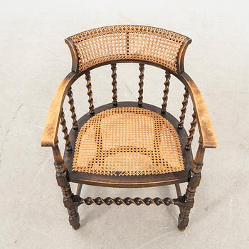 A rattan and wooden barocque-style chair from the first half of the 20th century.