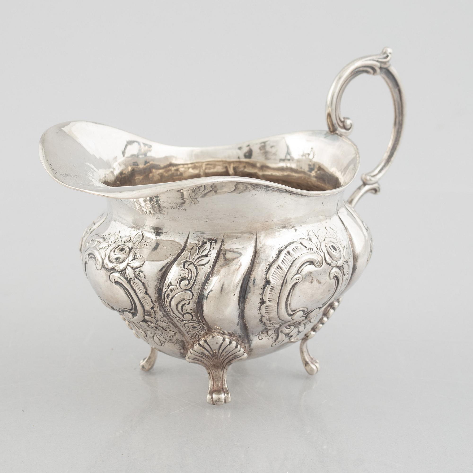 A Rococo-style silver coffee pot, creamer and sugar bowl, 20th Century.