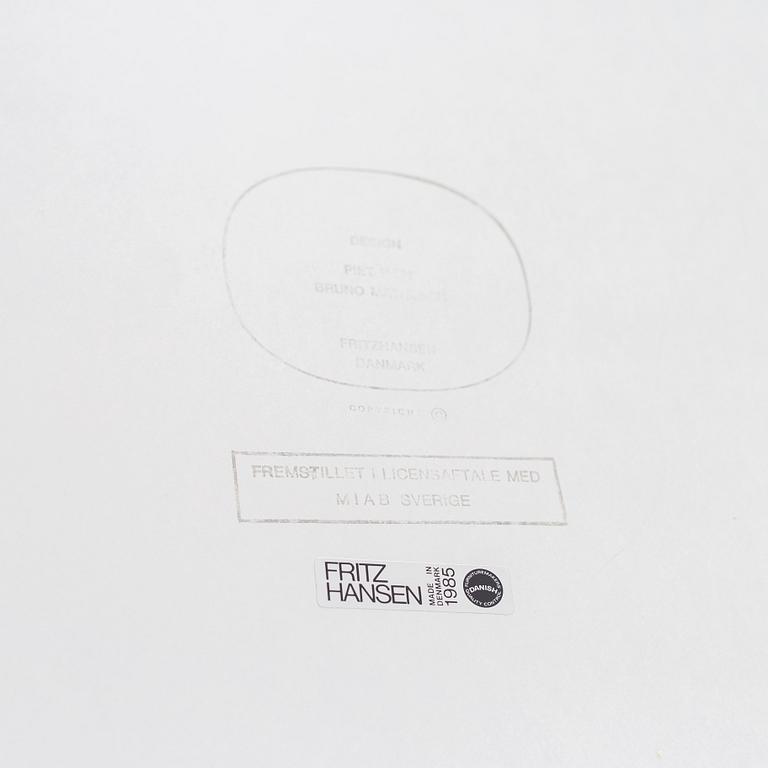 A 'Supercircular' table by Bruno Mathsson & Piet Hein for Fritz Hansen, dated 1985.