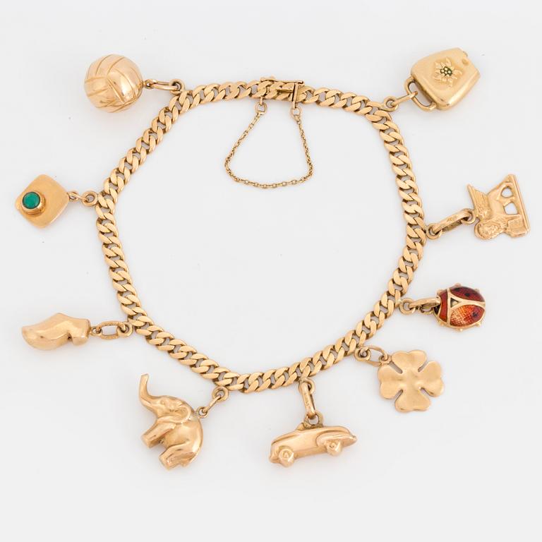 An 18K gold charm bracelet.