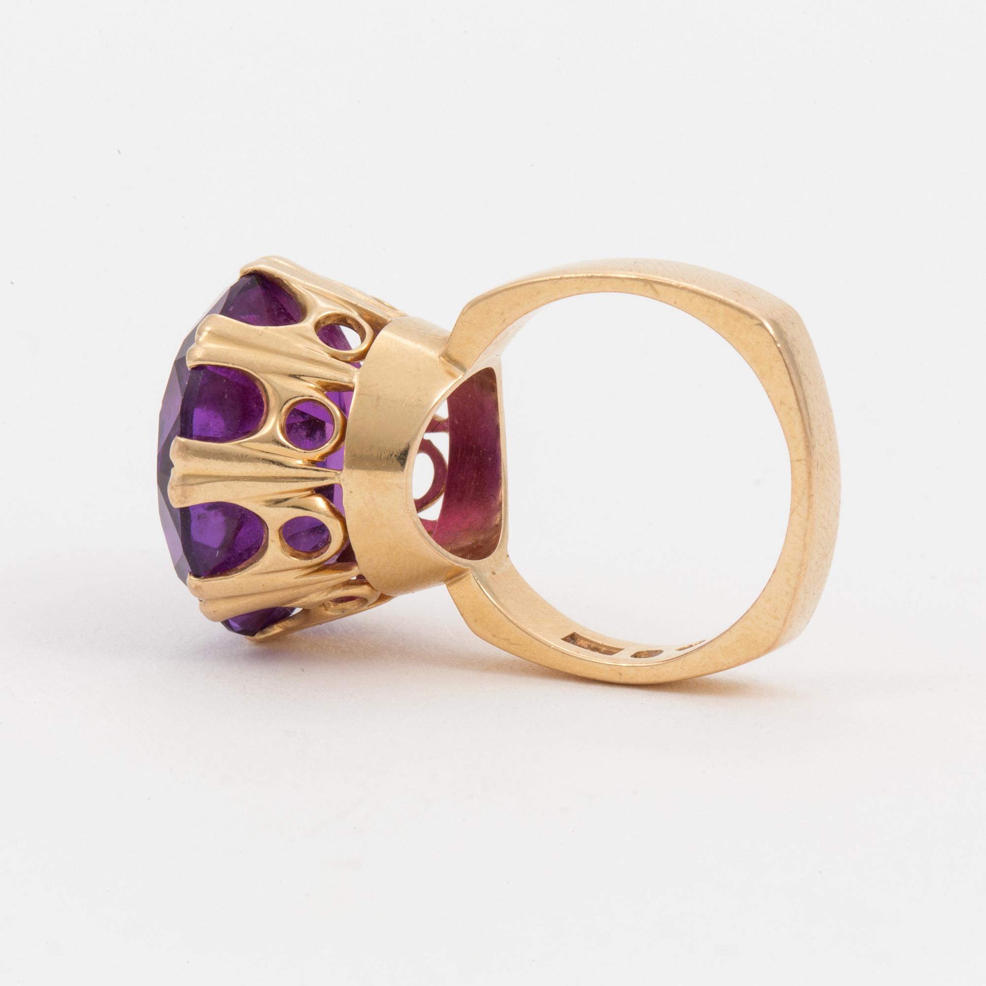 A ring set with a synthetic, purple sapphire.