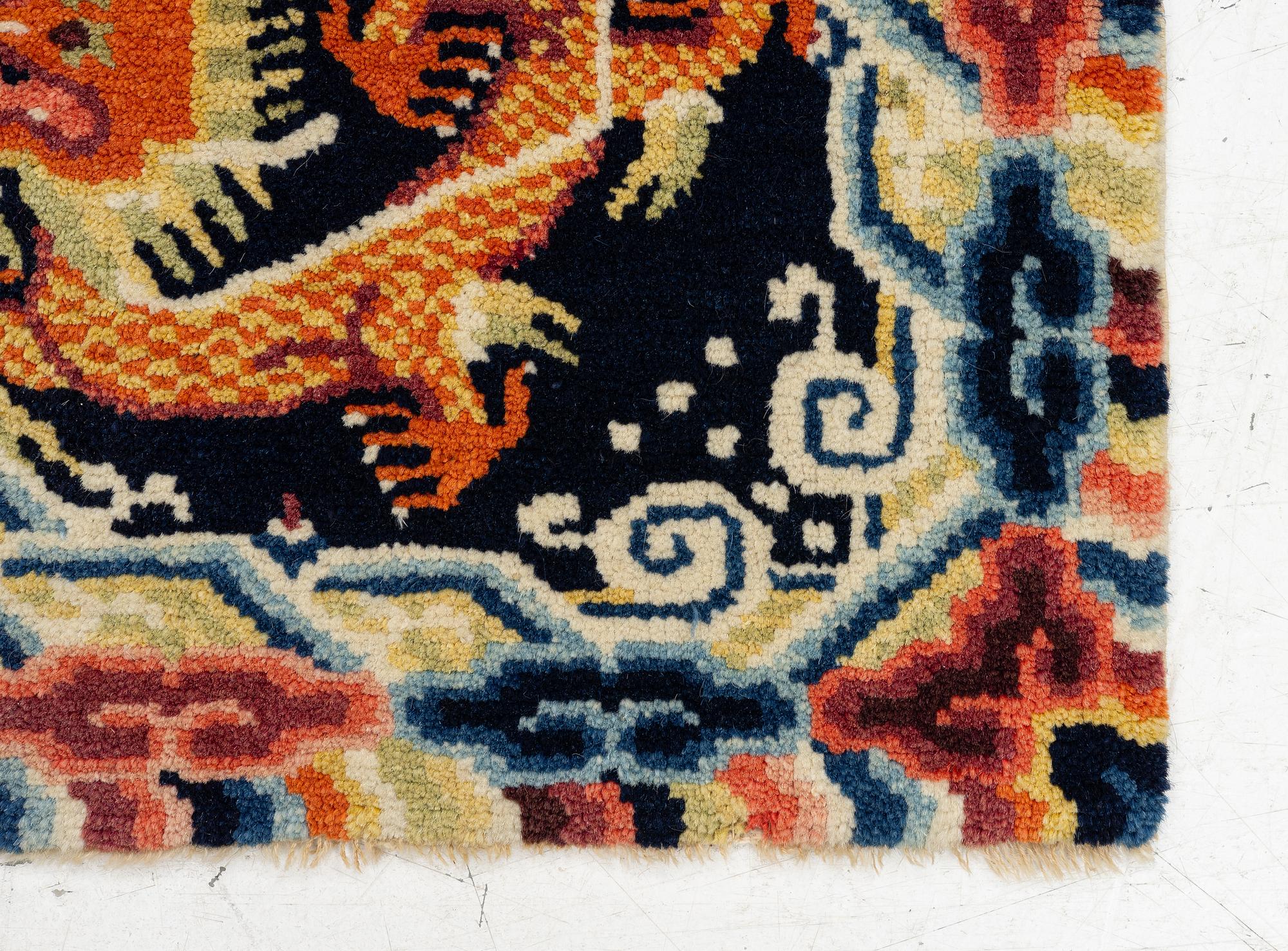 A Chinese small square rug, semi-antique, 65 x 68 cm.