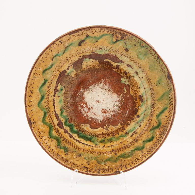 Two bowl plates ("Äggakagefat") 2 pieces from Skåne, one dated 1748 and 1891, engobed earthenware.