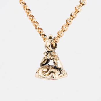 A carnelian seal in a chain.