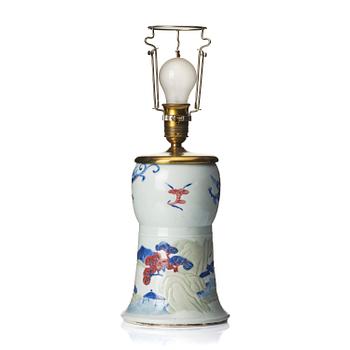 1014. A celadon, copper-red and underglaze blue carved beaker vase, Qing dynasty, Kangxi mark and of the period (1662-1722).