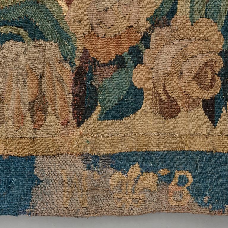 A TAPESTRY, tapestry weave, a "Verdure",  ca 304 x 224,5 cm, Flanders 17th century, signed "W" a lily "B".