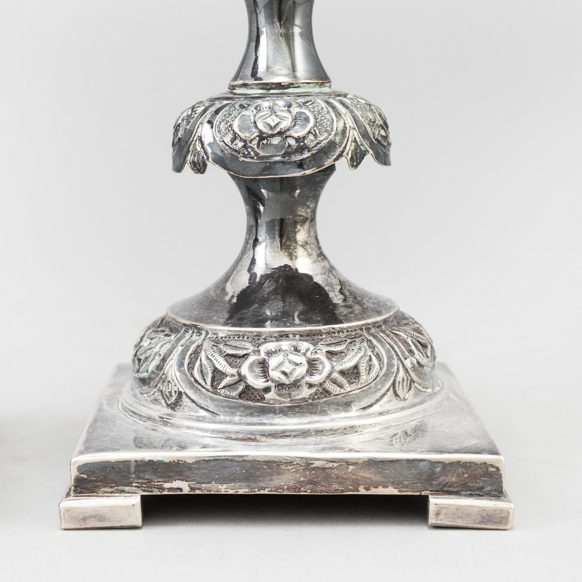A pair of silver Sabbath candlesticks, Maker M. Sztern, Warsaw, Poland. Assayer Josef Sosnkowski, 1864. Weight 833 g.