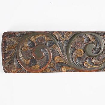 A carved and polychrome painted mangle board, Sweden, late 18th / early 19th century.