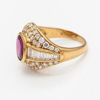 An 18K gold ring with baguette and brilliant cut diamonds and a ruby.