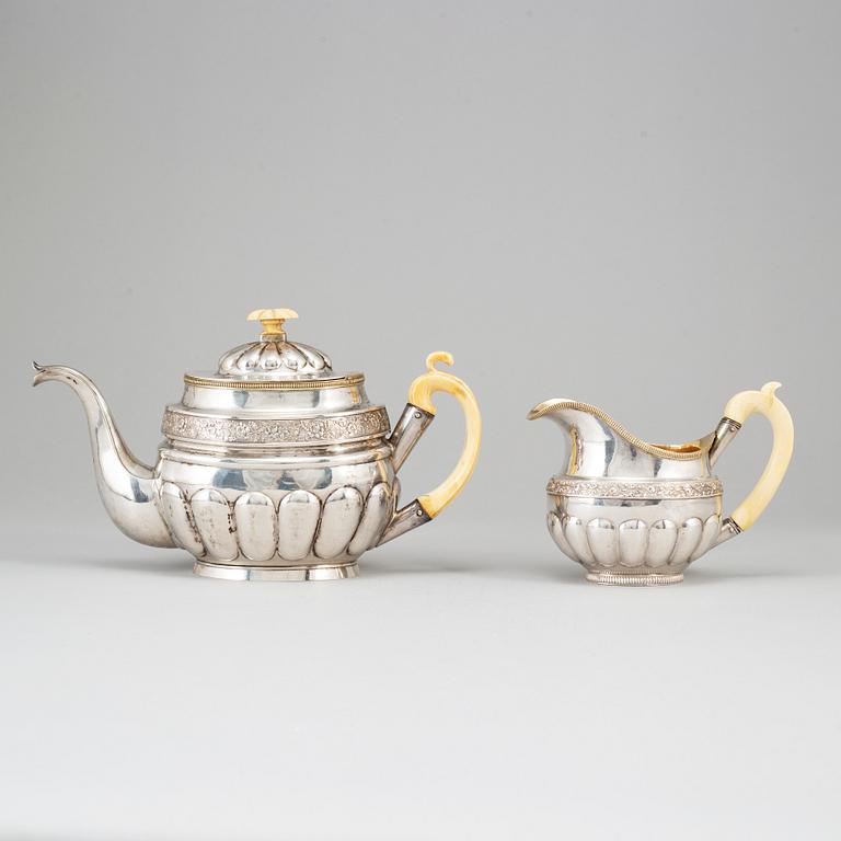 A Russian silver teapot and a parcel gilt silver creamer, Gustav Lindgren and Elias Modig, St Petersburg 1826-27.
